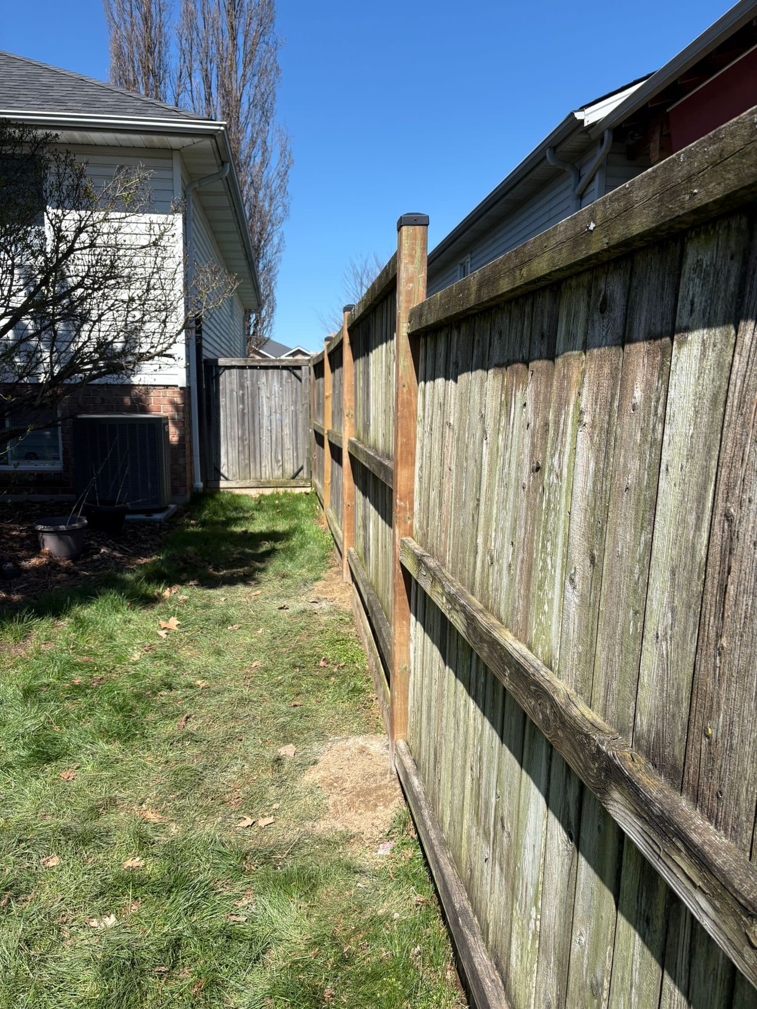 Leaning wood fence with structural issues
