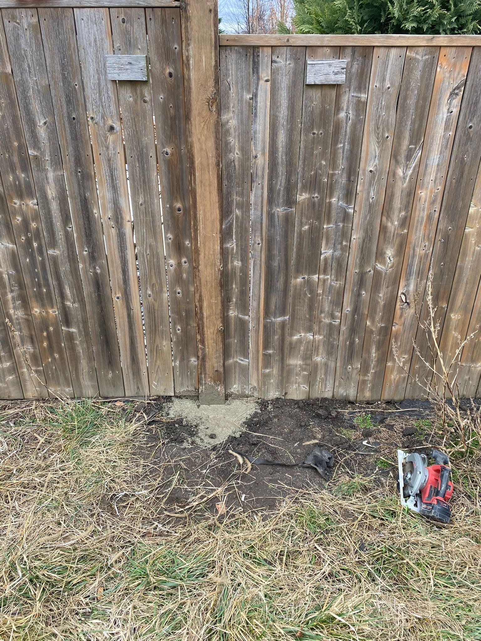 Sagging wood fence requiring post reinforcement