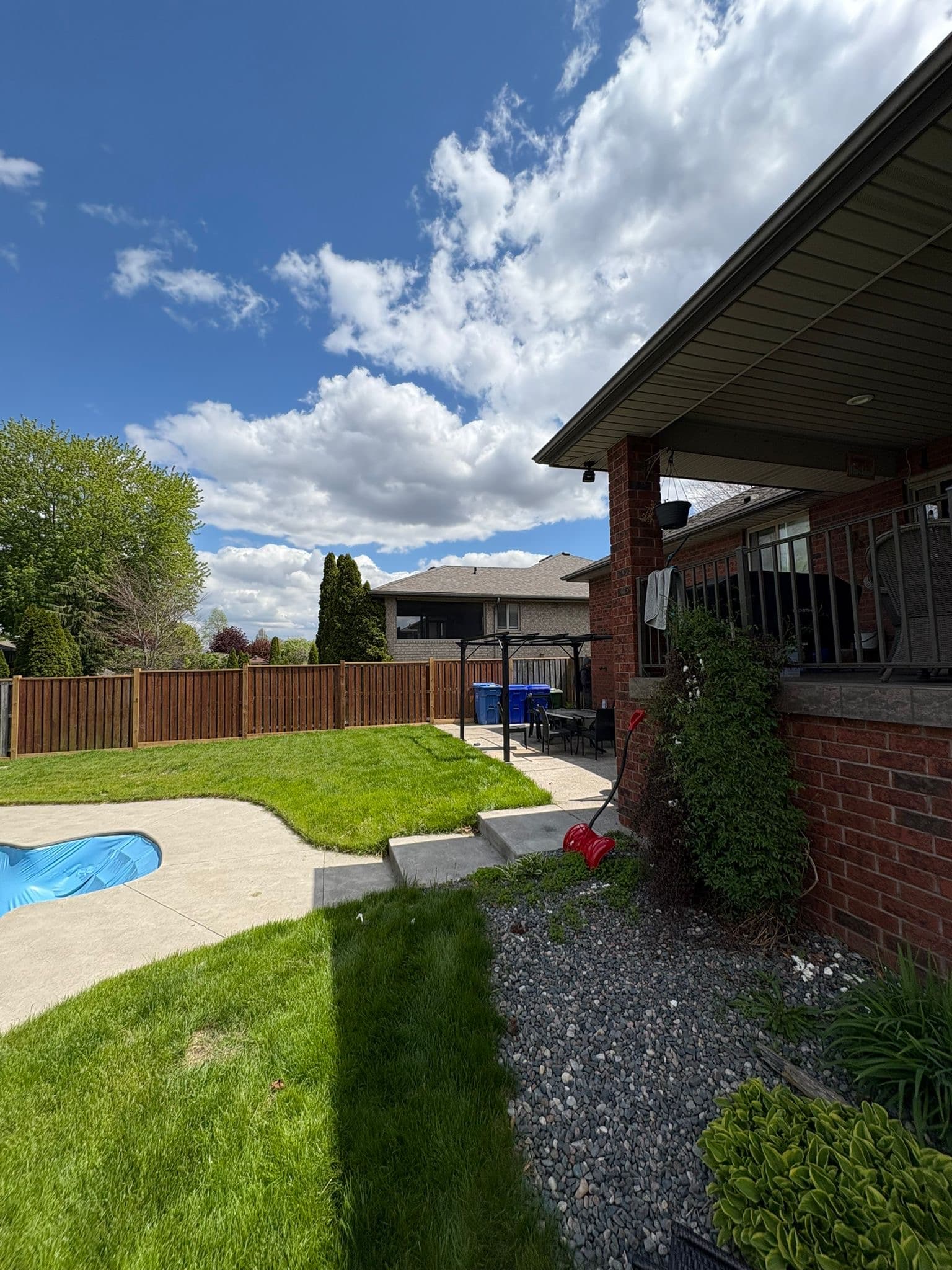 Wood fence in residential backyard with landscape