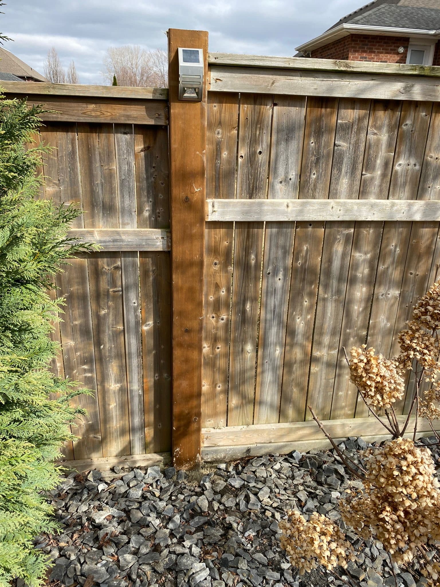 Weathered wood fence with broken boards