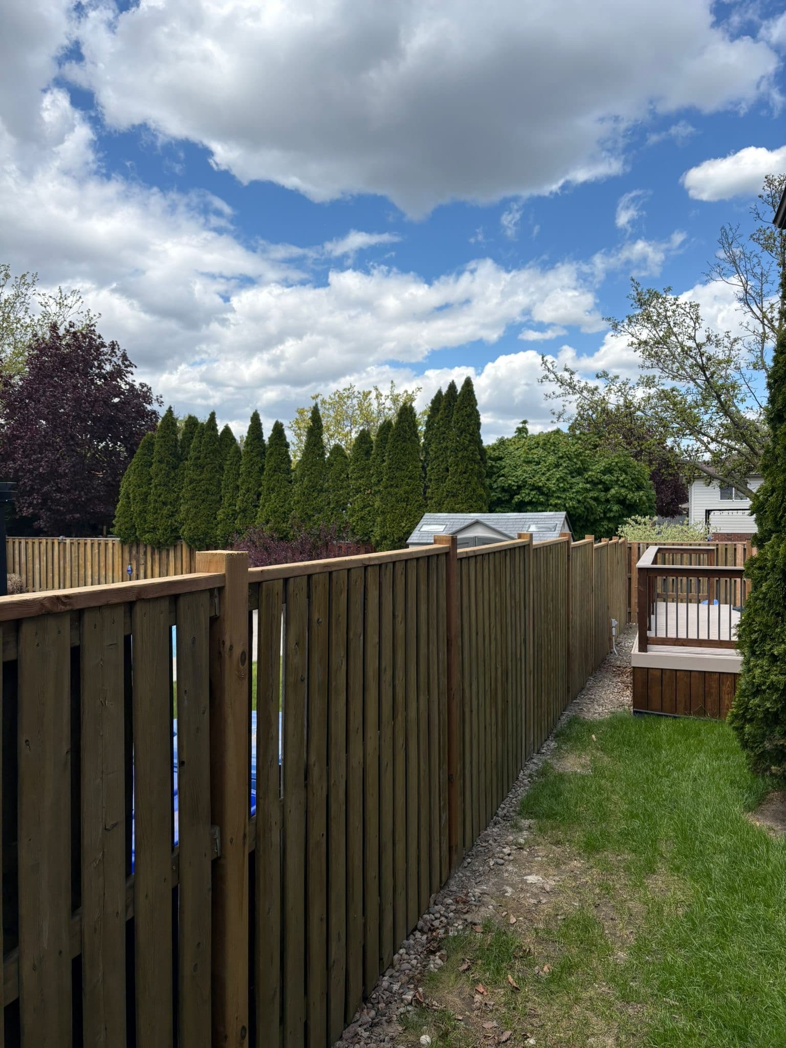 Long run of wood fence with gate repair