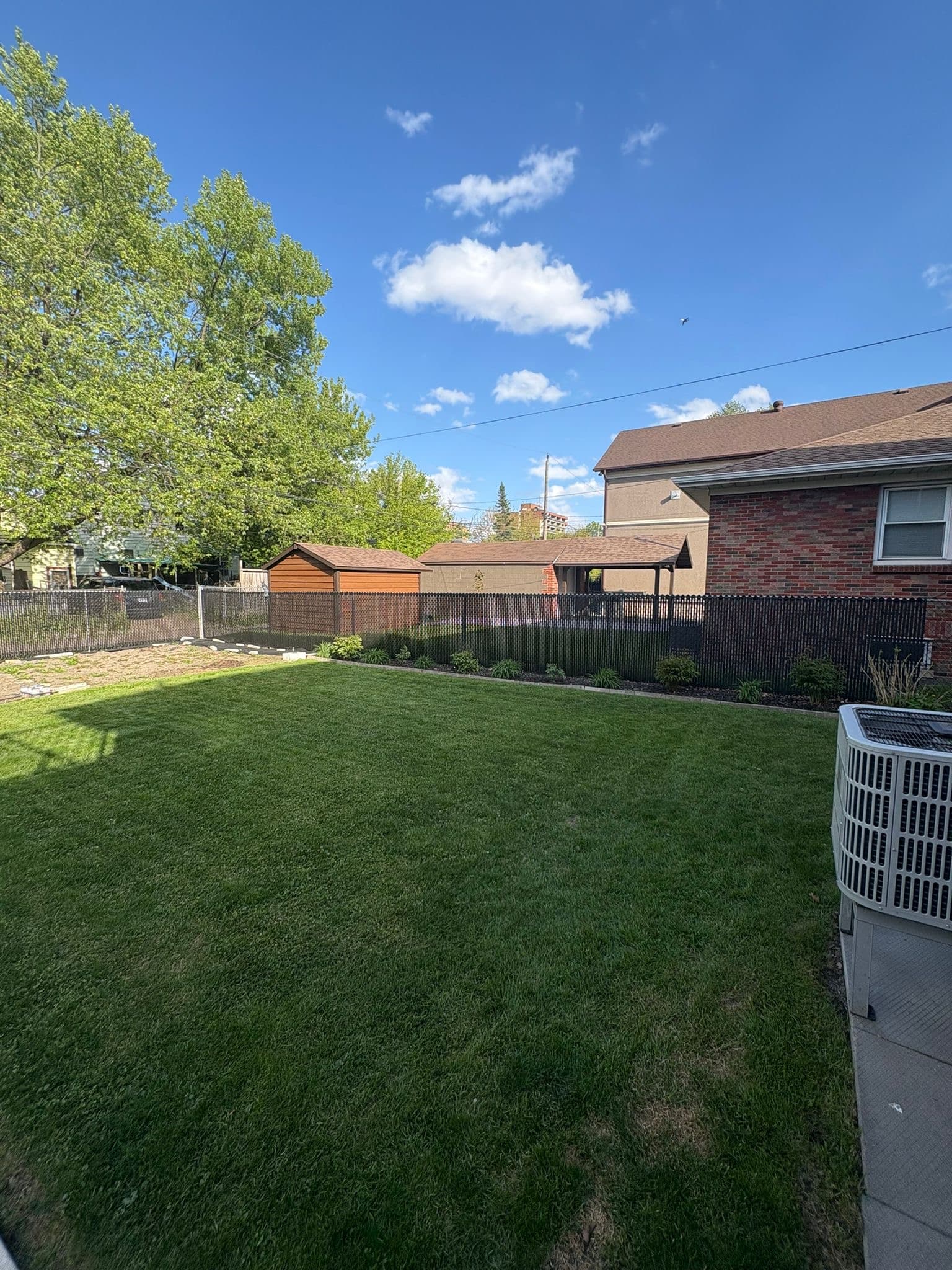 Brown chain link fence installation in yard