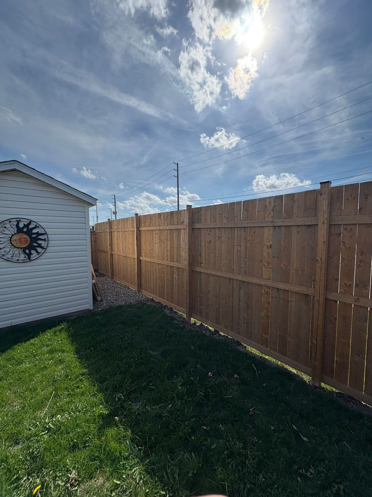 Modern wood fence with horizontal boards in narrow residential space